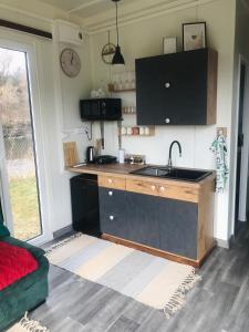 a kitchen with a sink and a counter top at TinyHouses & Garden in Oravská Poruba