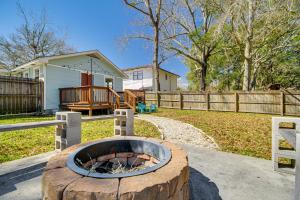 a fire pit in a yard next to a fence at Charming Gulf Coast Cottage - 1 Mile to the Coast! in Long Beach