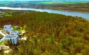 an aerial view of a building next to a river at FoRRest Longinówka II - garaż, klimatyzacja, widok, Netflix, Prime in Brodnica