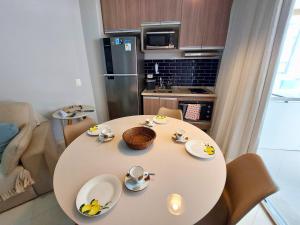 a table with plates and bowls of bananas on it in a kitchen at BookSantos Estanconfor 1503 -Charmoso e Próximo à Praia! in Santos