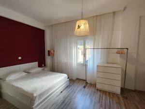 a bedroom with a white bed and a window at Superior Apartment Near Beach in Chania