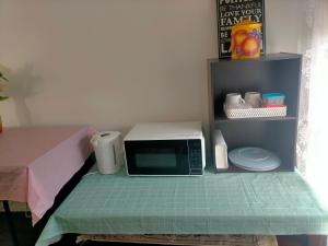 a microwave sitting on top of a table at Maha Melton Homestay in Melton South +3 photos