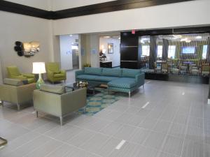 a lobby with couches and chairs and a waiting room at Holiday Inn Express & Suites Houston Northwest-Brookhollow by IHG in Houston