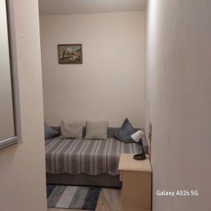 a small bed in a small room with a lamp at NATALI Appartamens Rosa in Malcesine +29 photos