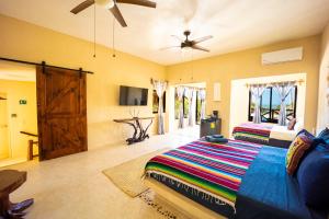 une chambre avec un lit et un ventilateur de plafond dans l'établissement 3 Bedrooms house shared pool, à Holbox