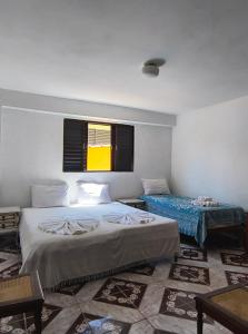 Ένα ή περισσότερα κρεβάτια σε δωμάτιο στο Pousada Casa Cristal Mineiro