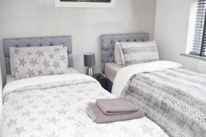 a bedroom with two beds with towels on them at The Grey Mansion in Manchester