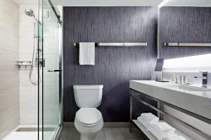 a bathroom with a toilet and a glass shower at New York Marriott Marquis in New York