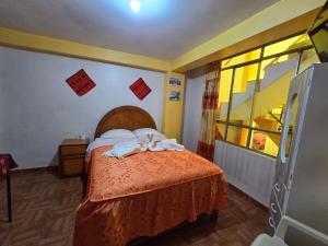 Postel nebo postele na pokoji v ubytování HOSTAL ACUARIUS PUNO