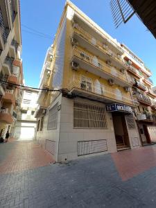 a large building with balconies on the side of it at Hotel Molí Beach in Benidorm