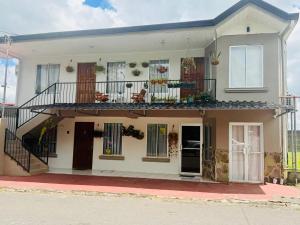 a large white house with a balcony on a street at Sweet Home Carrión in Fortuna