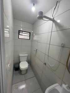 a white bathroom with a toilet and a sink at Flat J&C próx Praia da graciosa e UFT e Unitins in Palmas +14 photos