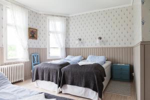 a bedroom with two beds and a blue cabinet at Amalia in Lemland