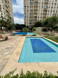 a large blue swimming pool in a large building at Desativado in São Luís
