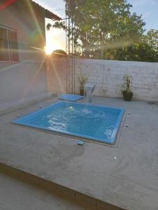 a hot tub on a patio with the sun setting at Casa MTB in Pirenópolis +1 photo
