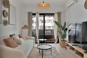 a living room with a couch and a table at Elegance and luxury with a pool in Miraflores Golf - CASA GOLF RIVIERA PARK 3 2 E in Mijas Costa
