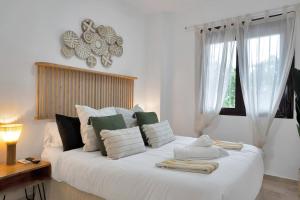 a bedroom with a large white bed with a window at Elegance and luxury with a pool in Miraflores Golf - CASA GOLF RIVIERA PARK 3 2 E in Mijas Costa +33 photos