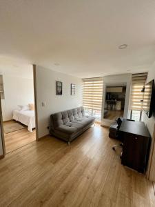a living room with a couch and a bed at Wonderful place in Usaquen! in Bogotá