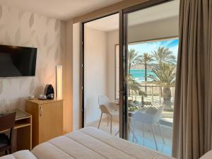 a hotel room with a bed and a view of the ocean at La Sort Boutique Hotel in Moraira