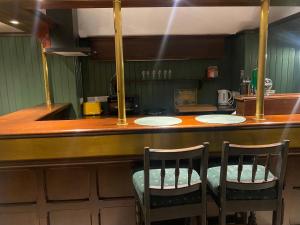 uma cozinha com um bar com três cadeiras em Top Deck em Killorglin