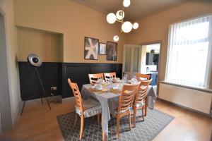 a dining room with a table and chairs at Central Cheerful Comfortable 3 Bedroom Home in Pallion
