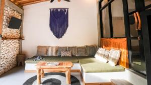 a living room with a couch and a table at Alma Surf Villas 2 - Cozy 01 Bed with Private Pool in Uluwatu +25 photos