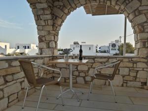 a table and two chairs on a stone patio at Stavento Apartments in Aliki
