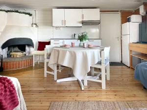 a kitchen with a table with chairs and a fireplace at Houses by The Sea in Salpar