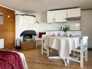 a dining room with a table and a fireplace at Houses by The Sea in Salpar