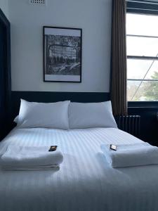 a bedroom with a bed with two towels on it at Royal Hotel Oberon in Oberon
