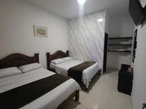 Voodi või voodid majutusasutuse Hotel Palmari toas