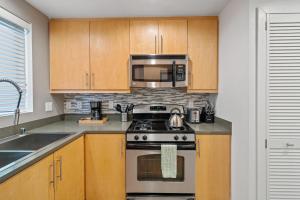 a kitchen with a stove and a microwave at Venice Marina Water Front Luxury Condo in Los Angeles