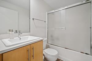 a bathroom with a sink and a toilet and a shower at Venice Marina Water Front Luxury Condo in Los Angeles +14 photos