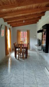 a dining room with a wooden table and chairs at La Reserva in Oberá +6 photos