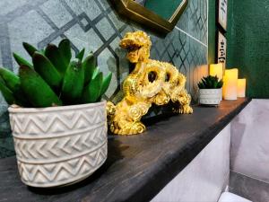 a gold lion statue sitting on a counter next to a potted plant at Asian Zen Den in Sparks