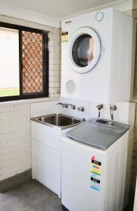 una cocina con fregadero y lavadora en Bathurst Motor Inn, en Bathurst