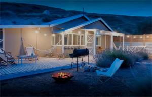 a house with a fire pit in front of it at Girasoles de Valdes in Puerto Pirámides