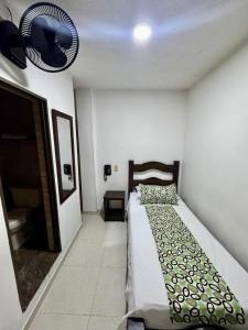 Rúm í herbergi á Hotel Tucan Pereira