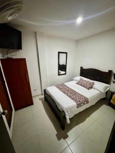 Rúm í herbergi á Hotel Tucan Pereira