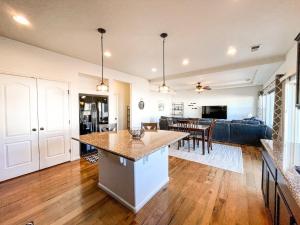 an open kitchen and living room with a counter top at Spacious Family Getaway 20min to downtown sights in Fountain