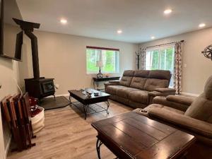 a living room with a couch and a wood stove at Chena Pointe Retreat in Fairbanks