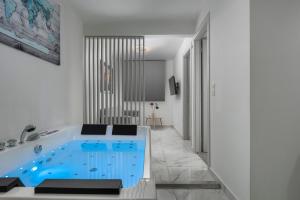 a bathroom with a blue tub in a room at PREMIUM JACUZZI SUITE at the City center, by Aqua Platinum in Thessaloniki