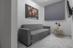 a living room with a couch and a table at PREMIUM JACUZZI SUITE at the City center, by Aqua Platinum in Thessaloniki