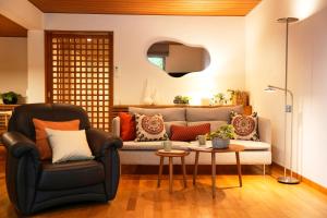 a living room with a couch and a table at Sakura Residence Hakone in Hakone