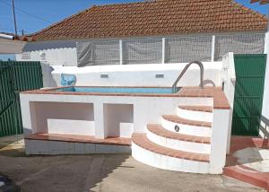 a house with a swimming pool and a staircase at Casa dos Pedro´s in Vila Nova