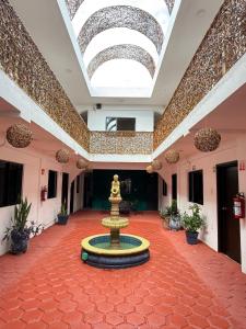 a fountain in the middle of a room with a ceiling at Hotel Casa Caracol in Isla Mujeres