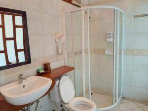 a bathroom with a shower and a toilet and a sink at Ireenkevin guesthouse in Luang Prabang +20 photos