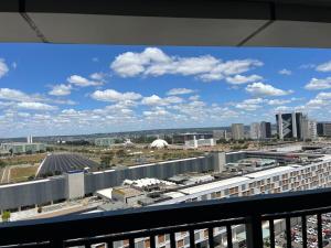 a view of a city from a balcony at M&V Flats - Prédio Vision - 1,5 km Mané Garrincha - 500m Esplanada dos Ministérios - Vaga de garagem - Ar condicionado - Cama queen size - Piscina - Academia in Brasilia