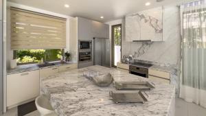 une cuisine avec un grand comptoir en marbre dans l'établissement Beachfront Luxury villa near Banyan Tree, à Layan Beach