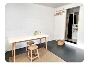 a kitchen with a table and two stools in a room at Detached Living Space in Rainbow Bay in Tweed Heads